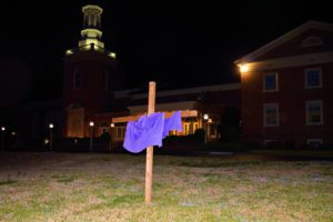 purple linen draped cross at night
