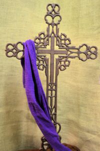 a fancy cross with a purpler drape