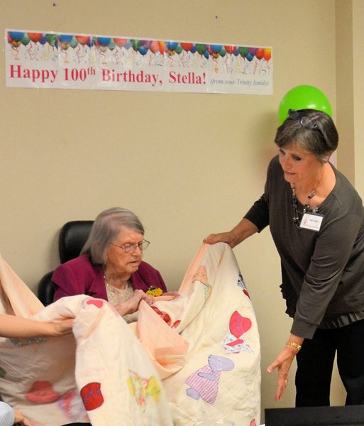 presenting a quilt to Stella on her 100th birthday.