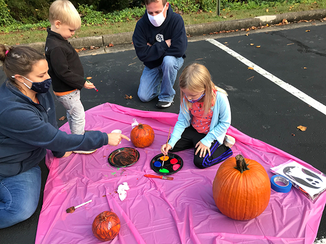 family painting pumpkins