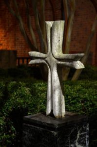 a cross in a garden at night