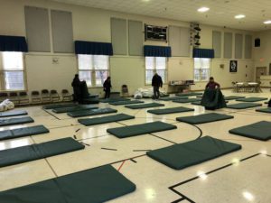 sleeping mats set out in a church gym