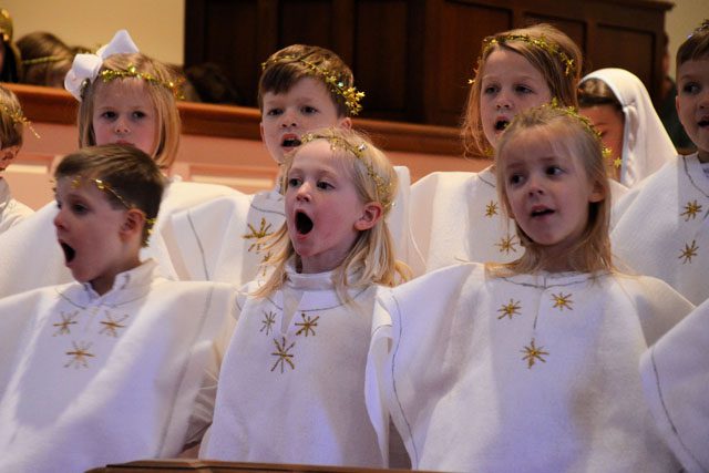kids dressed as angels singing