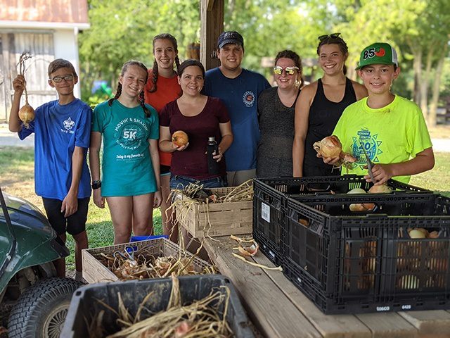 students together in a group while working at shalom farms