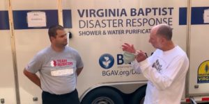 Video Capture: Team Rubicon-- 2 men in front of a trailer